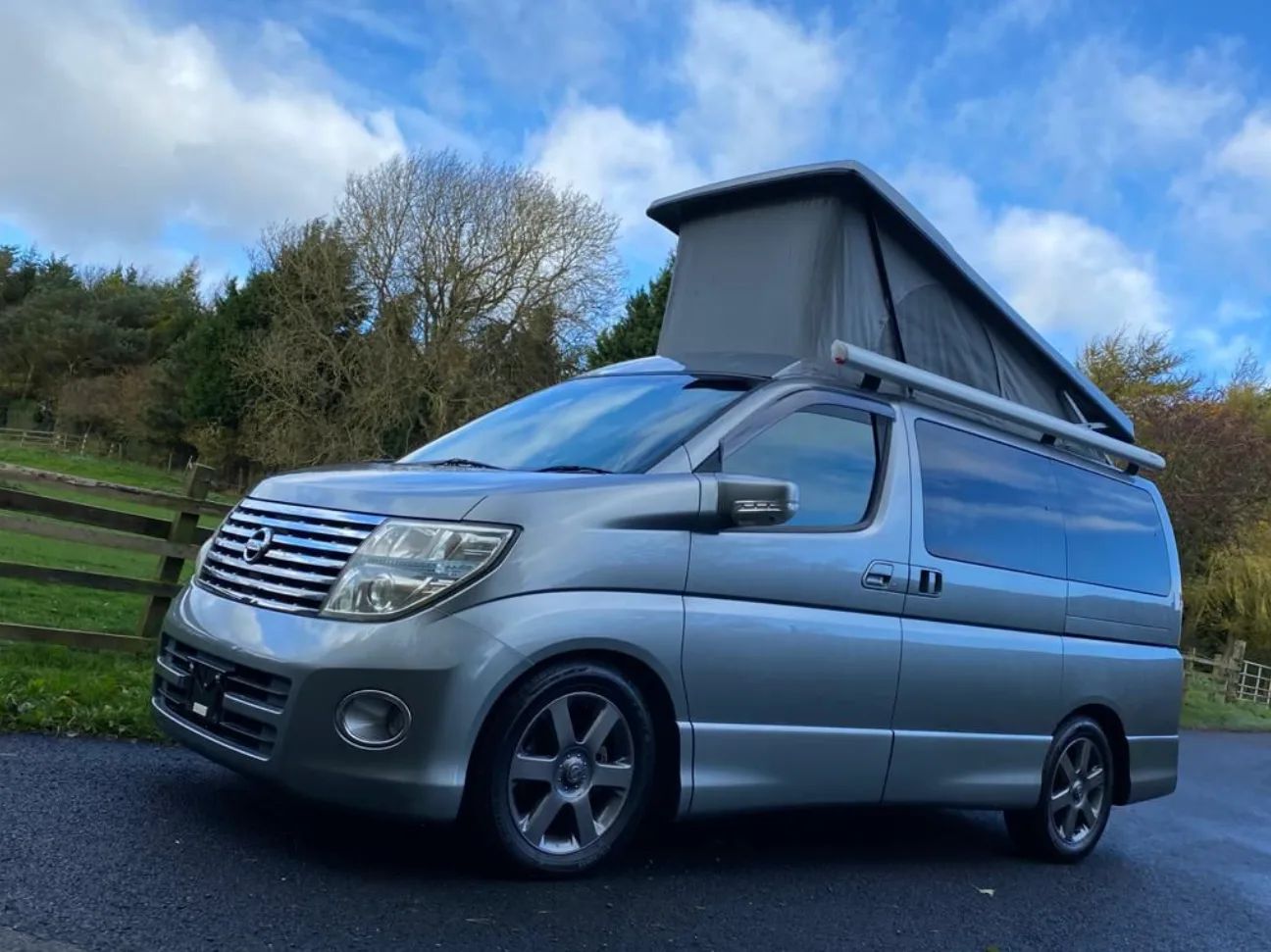 Silver Nissan Elgrand campervan with pop-top roof